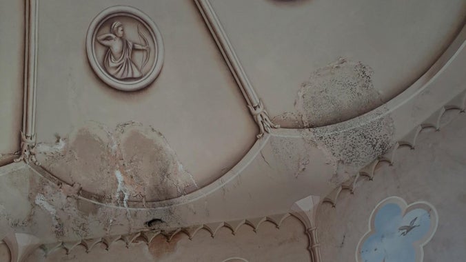 A close up of damage to paint and artworks on the ceiling of the Colby Gazebo at Colby Woodland Garden, Pembrokeshire